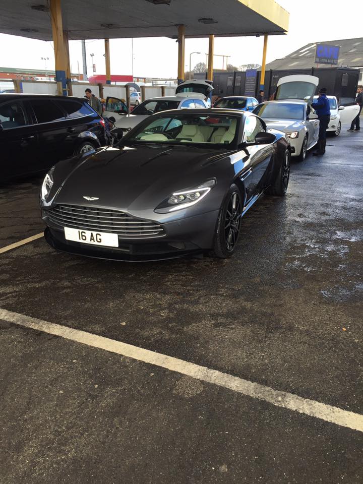 A dark grey Aston Martin sports car freshly washed at George's Car Wash